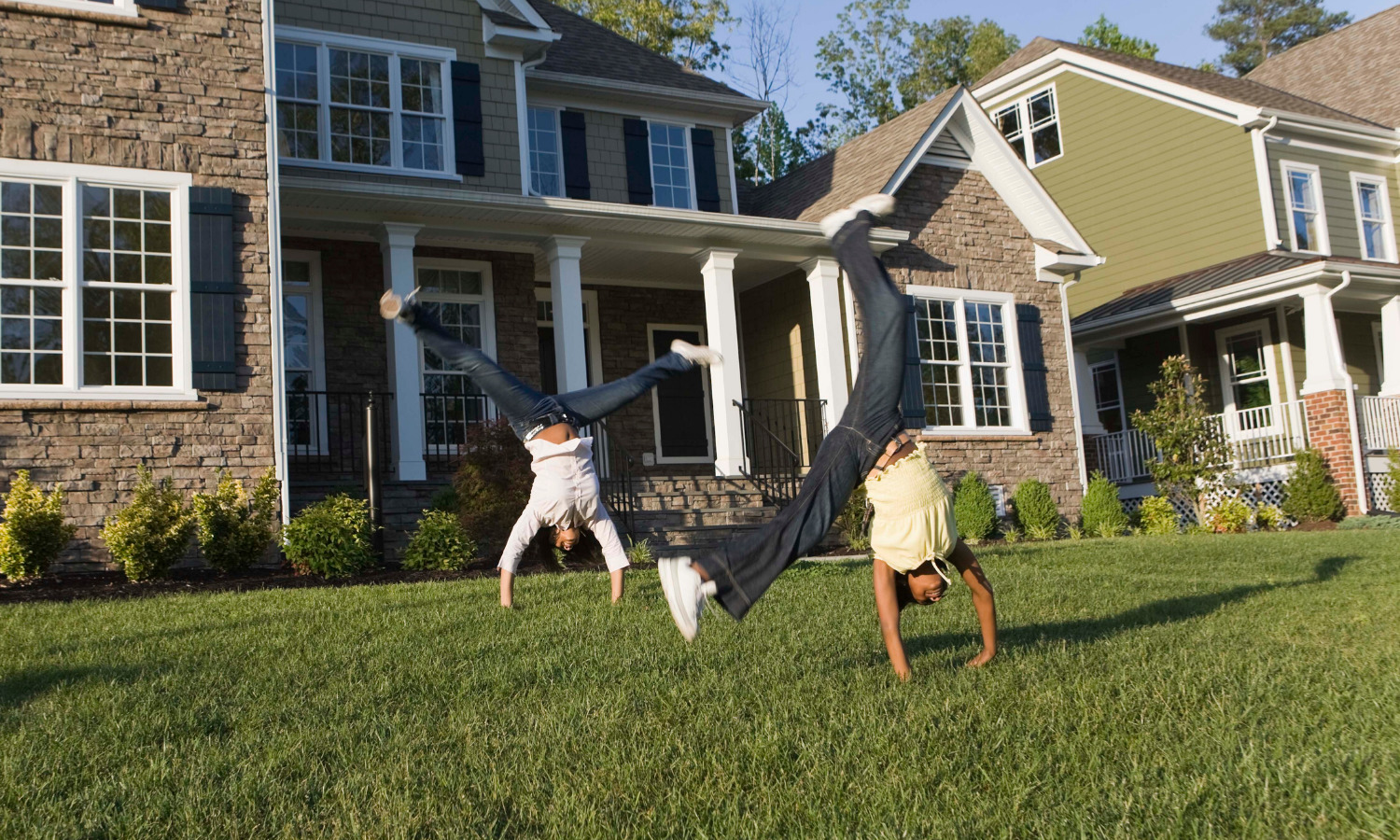 Photo of kids doing cartwheels on the lawn